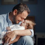 Middle,Age,Caucasian,Father,Kissing,Sleeping,Newborn,Baby,Girl.,Parent